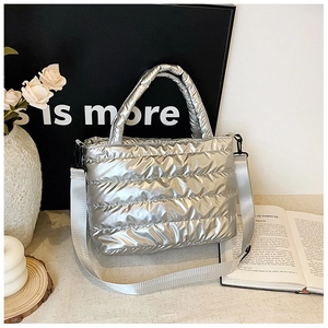 Detailed view of silver quilted tote bag with metallic finish and detachable strap