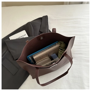 Top view of large dark brown tote bag interior showing spacious storage for daily items