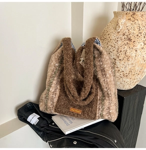 Detail of plush tote bag with brown textured fabric and classic blue plaid inner lining