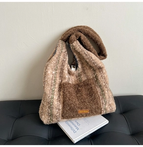 Close-up of plush striped tote bag with furry pocket and inner checkered lining detail