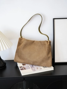 Detail of vintage brown suede Boston bag with green leather strap and gold buckle