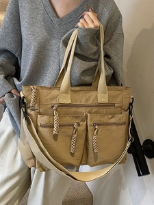 Khaki multi-pocket tote bag with woven zipper pulls and detachable wide shoulder strap