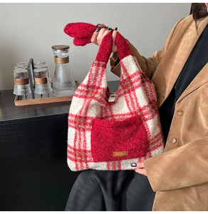Detail of red and white checkered plush knit tote bag with small pocket shown in hand