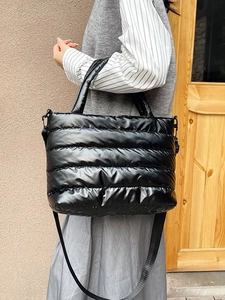 Stylish black quilted puffer tote bag with adjustable shoulder strap for autumn and winter