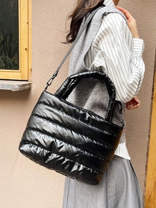 Chic black quilted puffer tote bag for women with glossy finish and shoulder strap