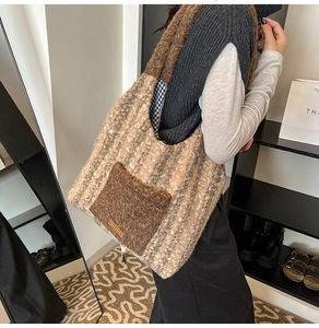 Detail of tweed tote bag featuring plush pocket, autumn stripes, and embroidered label