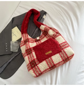 Detail of plush red plaid tote bag with lamb wool texture and faux fur handles