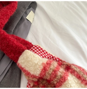 Close-up of red and pink checkered plush tote bag with lamb wool texture and stitching details