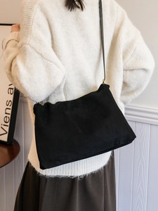 Classic black suede Boston bag shown as a crossbody pillow bag for chic daily commuting