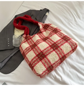 Detail shot of plush red and white checkered tote bag with soft fleece texture and warm style