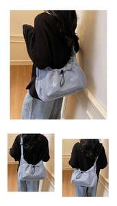 Detail view of light blue corduroy tote bag with star patterns and drawstring closure