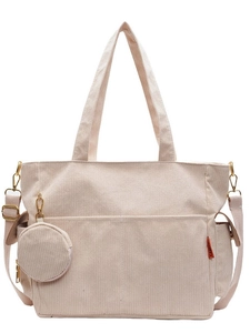 Off-white corduroy tote bag with adjustable strap and small coin purse on white background