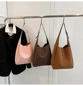 Detailed display of minimalist tote bags in pink, brown and caramel suede texture