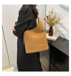 Detail of the brown suede hobo bag showing large capacity and adjustable shoulder strap
