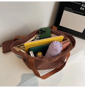 Brown knit tote bag interior showing large capacity for phone, umbrella, and wallet