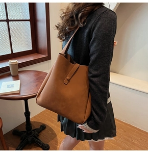 Close-up of caramel microfiber bucket bag with matte texture and decorative snap closure