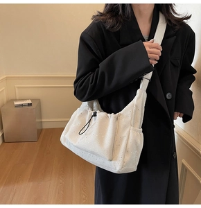 Detail of off-white corduroy tote bag with subtle glitter finish and drawstring design