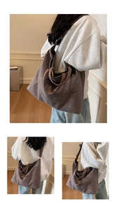 Detail showing the thick canvas texture and adjustable brown strap of the large tote bag