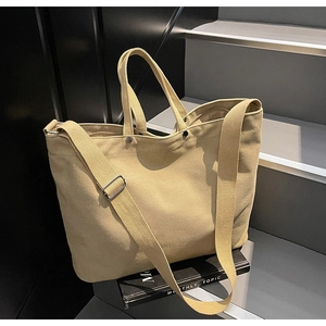 Detail of canvas tote bag with adjustable shoulder strap and metal snap closure