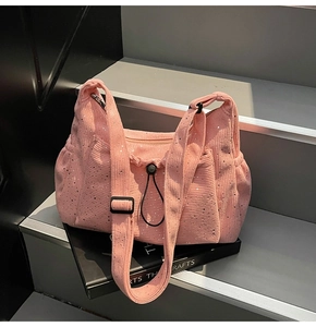 Detail of pink corduroy shoulder bag with silver sequins and adjustable black strap