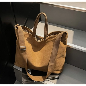 Macro detail of brown canvas tote bag featuring metal rivets and thick durable fabric