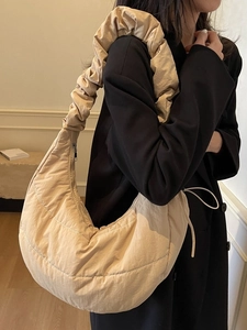 Chic quilted beige oversized puffy hobo bag with trendy ruched shoulder strap and zipper
