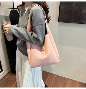 Detailed view of pink hobo shoulder bag in soft suede fabric with adjustable metal strap