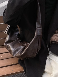 Retro dark brown crescent shoulder bag with pleated leather texture and large capacity