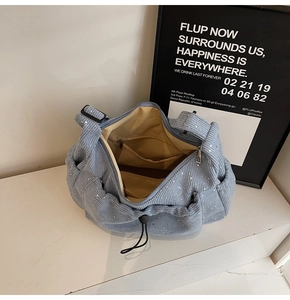 Interior view of light blue corduroy tote bag showing yellow lining and inner pockets
