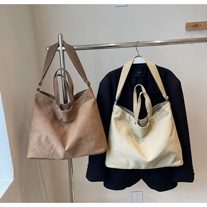 Dual-color canvas tote bags with adjustable straps in brown and creamy white finish