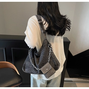 Detail of grey washed denim tote bag featuring chunky silver chain and mini pouch