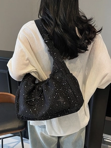 Minimalist black nylon pleated crossbody bag with white speckled pattern and drawstring