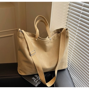 Detail of khaki canvas tote with adjustable strap and metal buckle for daily commute