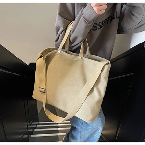 Detail of khaki heavy canvas tote bag with adjustable strap and metal rivet reinforcement
