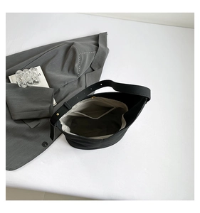 Interior view of minimalist black tote showing spacious main compartment and zip pocket