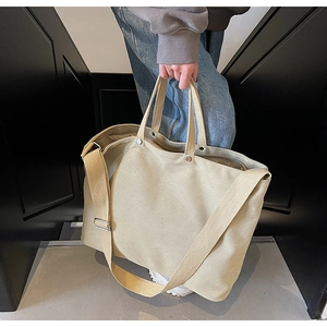 Detailed macro view of the durable thick canvas fabric and handle stitching on the tote bag