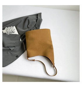 Detail view of the caramel brown matte leather tote with adjustable shoulder strap