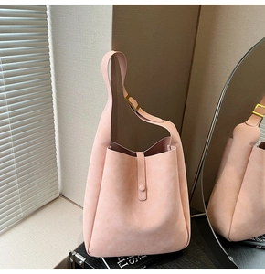 Detail of soft pink nubuck tote bag with wide strap and metallic adjustable buckle