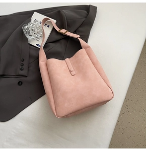 Detailed top view of a pink suede Hobo shoulder bag with golden hardware and adjustable strap
