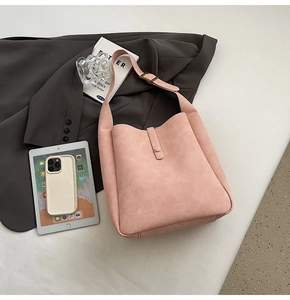 Pink faux suede tote bag with adjustable strap styled with office accessories