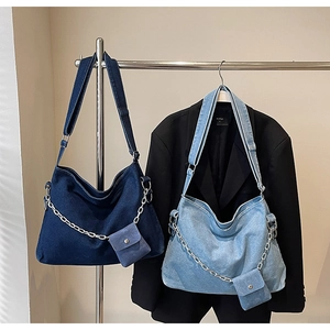 Detail of denim hobo bags with silver chain ornaments and matching mini pouches