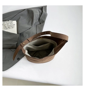 Detailed interior of dark brown bucket bag with magnetic clasp and zipper pocket