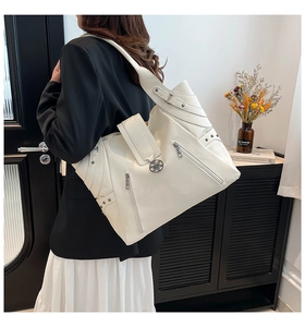 Detailed view of white litchi texture PU tote bag with metal zipper and floral lock
