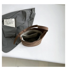 Top view of large brown bucket bag showing spacious interior and zipper pocket
