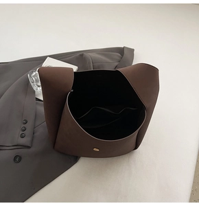 Top view of dark brown tote bag interior with magnetic gold buckle and inner pocket