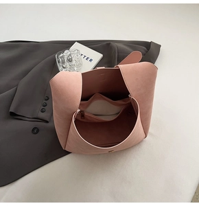 Top view of pink suede handbag interior with zipper pocket and magnetic closure