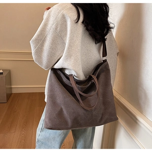 Detailed view of the dark brown thick canvas tote bag featuring adjustable shoulder straps