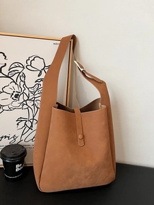Brown suede shoulder bag with wide strap and minimalist vintage tote design