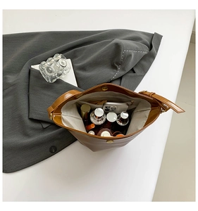 Top view of brown glossy leather tote interior showing spacious storage and inner pocket