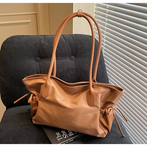 Détail du sac cabas en nylon marron et cuir avec cordon de serrage latéral élégant